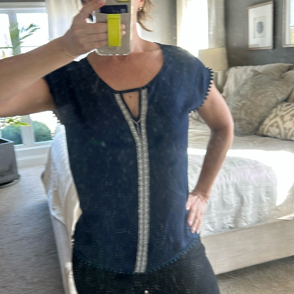 Sheer blouse with beaded detail.